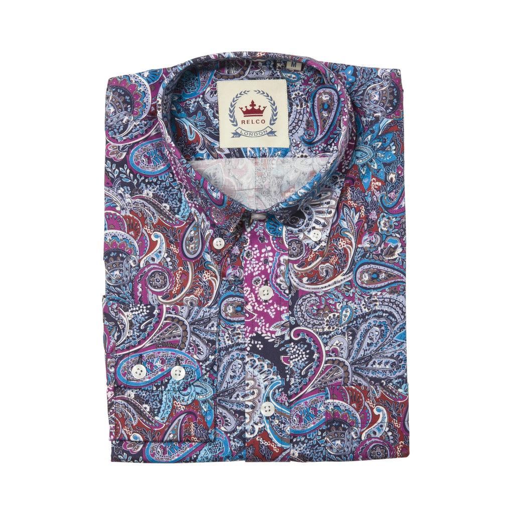 A folded long-sleeve button-up shirt with a vibrant paisley pattern in blue, purple, red, and white, featuring a visible Melco brand label on the collar.